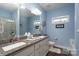 Bathroom featuring granite countertops, double sinks, and modern fixtures at 17438 Purser Dr, Locust, NC 28097