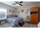 Cozy bedroom with a striped bedspread, bedside table, and a trunk at the foot of the bed at 17438 Purser Dr, Locust, NC 28097