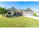 Charming single-story home with a manicured lawn, a two-car garage, and a welcoming front porch at 17438 Purser Dr, Locust, NC 28097