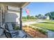 Cozy front porch featuring a swing, seating, and well-maintained landscaping at 17438 Purser Dr, Locust, NC 28097
