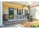 Close-up of welcoming front porch with seating and charming decor at 17438 Purser Dr, Locust, NC 28097