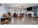 Cozy living room featuring a fireplace, wood floors, and comfortable leather furniture at 17438 Purser Dr, Locust, NC 28097