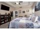Main bedroom with ensuite bathroom, sitting area and ceiling fan at 17438 Purser Dr, Locust, NC 28097