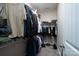 Organized walk-in closet with ample hanging space, shelving, and storage for clothing and shoes at 17438 Purser Dr, Locust, NC 28097