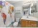 A bathroom with a sink, toilet, and a shower curtain featuring a world map at 1912 Baxter St, Charlotte, NC 28204
