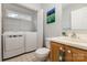 This bathroom features a white vanity, toilet, and full-size washer and dryer at 1912 Baxter St, Charlotte, NC 28204