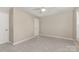 Bright, neutrally decorated bedroom featuring multiple windows and doors, with soft carpet flooring at 1912 Baxter St, Charlotte, NC 28204
