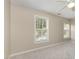 This neutral bedroom features multiple windows that provide bright natural light at 1912 Baxter St, Charlotte, NC 28204