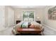 Bright bedroom features a large window, soft carpet, and decorative throw pillows for a modern feel at 1912 Baxter St, Charlotte, NC 28204