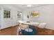 Bright dining area featuring hardwood floors, modern white table and four chairs at 1912 Baxter St, Charlotte, NC 28204