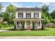 Traditional two-story home with a welcoming porch and manicured front yard at 1912 Baxter St, Charlotte, NC 28204