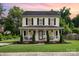 Charming two-story home with a welcoming front porch and well-manicured lawn at 1912 Baxter St, Charlotte, NC 28204