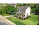 Aerial view of a beautiful two-story home with a well-manicured lawn, lush landscaping, and a welcoming front porch at 1912 Baxter St, Charlotte, NC 28204