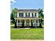 Charming two-story home featuring a covered front porch and well-manicured landscaping at 1912 Baxter St, Charlotte, NC 28204