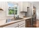 Well-lit kitchen featuring stainless steel appliances, a window view, white tile backsplash, and ample counter space at 1912 Baxter St, Charlotte, NC 28204