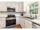 Bright kitchen featuring stainless steel appliances, white cabinets and modern fixtures at 1912 Baxter St, Charlotte, NC 28204