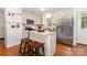 Bright kitchen featuring an island with bar seating and stainless steel appliances at 1912 Baxter St, Charlotte, NC 28204