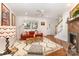 Bright living room features hardwood floors, fireplace and comfortable seating at 1912 Baxter St, Charlotte, NC 28204