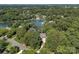 Stunning aerial perspective showcases an estate nestled amidst a lush forest along the waterfront property at 19506 Mary Ardrey Cir, Cornelius, NC 28031