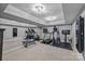 Spacious basement gym with modern exercise equipment and a mirrored wall at 19506 Mary Ardrey Cir, Cornelius, NC 28031