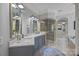 Luxurious bathroom featuring dual sinks, a glass enclosed shower, and access to a walk-in closet at 19506 Mary Ardrey Cir, Cornelius, NC 28031
