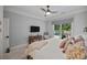 Cozy bedroom with a window view, decorative pillows, and a ceiling fan at 19506 Mary Ardrey Cir, Cornelius, NC 28031