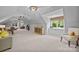 Spacious bonus room with vaulted ceilings, built-in cabinets, and ample seating areas at 19506 Mary Ardrey Cir, Cornelius, NC 28031
