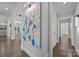 Bright hallway featuring wood floors, white trim, and an abstract art piece at 19506 Mary Ardrey Cir, Cornelius, NC 28031