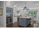 This kitchen has a stylish island, stainless steel appliances, and a breakfast area for casual dining at 19506 Mary Ardrey Cir, Cornelius, NC 28031