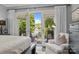 This primary suite opens to a private balcony with scenic water views and a comfortable seating area at 19506 Mary Ardrey Cir, Cornelius, NC 28031