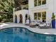 Backyard pool with an outdoor seating area, patio, and elegant landscaping at 19506 Mary Ardrey Cir, Cornelius, NC 28031