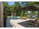Luxurious pool and spa area with elegant patio furniture and lush landscaping at 19506 Mary Ardrey Cir, Cornelius, NC 28031