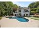 Expansive backyard with a luxurious pool, spa, and manicured lawn at 19506 Mary Ardrey Cir, Cornelius, NC 28031