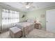Comfortable bedroom with light green walls, plush carpet, and natural light from the window at 2769 Independence Way, Gastonia, NC 28056