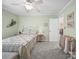 Cozy bedroom with neutral-toned walls, soft carpet, ceiling fan and view to the stairs at 2769 Independence Way, Gastonia, NC 28056