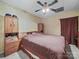 Bedroom with a dark bedspread and matching brown wooden furniture at 2769 Independence Way, Gastonia, NC 28056