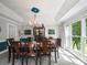 Formal dining room featuring a large table, chandelier, and natural light from large windows at 2769 Independence Way, Gastonia, NC 28056