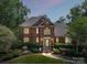 Charming two-story brick home with manicured lawn and landscape at twilight at 2769 Independence Way, Gastonia, NC 28056