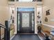 Elegant foyer with a decorative front door and recessed shelving with decorative items at 2769 Independence Way, Gastonia, NC 28056