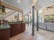 Open-concept living space featuring a wet bar, staircase, and living room with tall columns at 2769 Independence Way, Gastonia, NC 28056