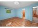 Bright bedroom with hardwood floors, window, and light blue walls and trim at 2831 Puetts Chapel Rd, Bessemer City, NC 28016