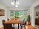 Cozy dining room featuring hardwood floors, a bay window with yard views, and a stylish wooden table with seating at 2831 Puetts Chapel Rd, Bessemer City, NC 28016
