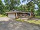 Charming exterior of the home with a two-car garage, brick facade and a spacious front yard at 2831 Puetts Chapel Rd, Bessemer City, NC 28016