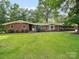 Charming single-story brick home with a well-manicured lawn and mature trees in a peaceful setting at 2831 Puetts Chapel Rd, Bessemer City, NC 28016