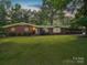 Charming brick home with a well-manicured lawn and mature trees, offering a serene and inviting curb appeal at 2831 Puetts Chapel Rd, Bessemer City, NC 28016