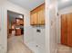 Hallway with wood cabinets, vintage tile, and access to other rooms at 2831 Puetts Chapel Rd, Bessemer City, NC 28016