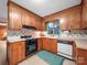 Cozy kitchen featuring wood cabinetry, a black oven, and a classic white sink at 2831 Puetts Chapel Rd, Bessemer City, NC 28016