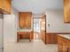 Charming kitchen with built-in desk, wood cabinets, and unique patterned flooring at 2831 Puetts Chapel Rd, Bessemer City, NC 28016