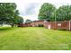 Lush, green backyard of a brick home, complete with a detached garage and mature trees at 2836 20Th Street Ne Ln, Hickory, NC 28601