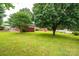 Expansive green backyard featuring lush lawn and mature trees, perfect for outdoor activities and relaxation at 2836 20Th Street Ne Ln, Hickory, NC 28601